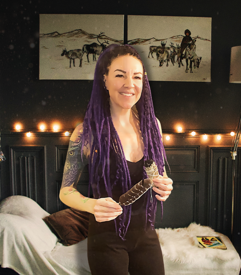 Tami of Spellbound Spaces holding sage and feather for ritual home cleansing and energy clearing in Salt Lake City